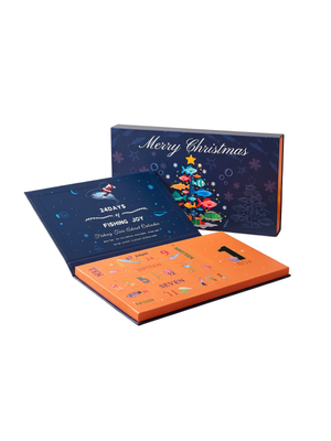 A Christmas-themed 28-day fishing joy advent calendar shown open, with a dark blue outer box reading 'Merry Christmas' and a bright orange inner tray containing daily fish-themed cards, photographed on a clean white background.