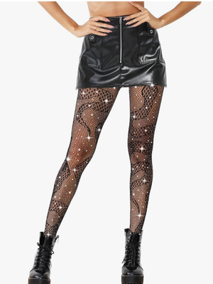 A model wearing black snakeskin-print fishnet tights with silver rhinestone accents, styled with a black faux-leather mini skirt and black platform combat boots against a plain white background.