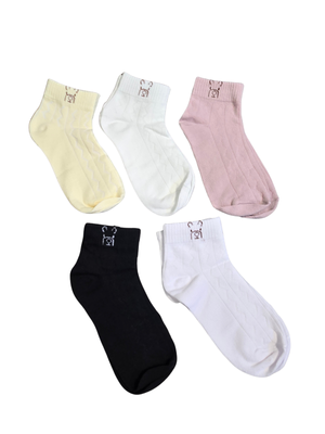 Five ankle socks in assorted colors, including pale yellow, white, light pink, and black, arranged on a plain white background. Each sock features a small embroidered character on the cuff.